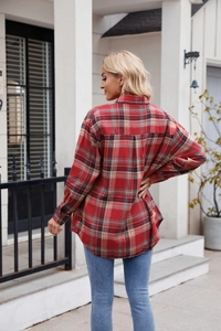 Detailed close-up of a red and black plaid shirt with pockets and soft casual fabric