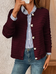 Detail of burgundy knit cardigan featuring chunky texture and large white buttons