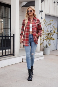 Detail of red plaid shacket showing textured brushed fabric and double chest pockets