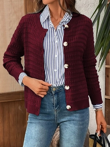 Detail of burgundy knitted cardigan with white buttons and 3D textured fabric for women
