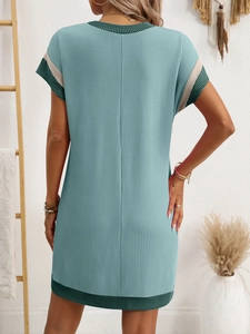 Detail showing knit texture and green contrast trim on back of blue short sleeve dress