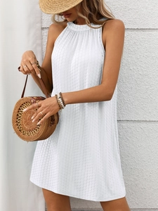 Detail showing the white halter neck dress with vertical textured fabric and A-line cut