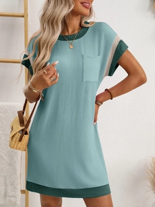 Detail of light green waffle knit dress with dark green trim and chest pocket detail