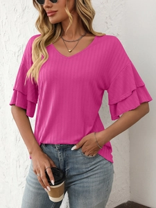 Detail of rose pink V-neck top showing ruffled sleeves and vertical striped fabric texture