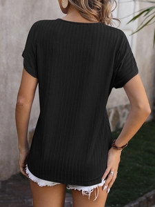 Close-up of black ribbed knit short sleeve top showing textured fabric and casual fit