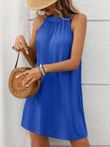 Close-up of royal blue summer dress showing vertical pleated texture and halter neckline