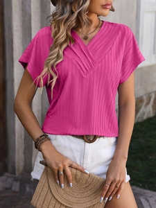 Close-up of bright rose pink V-neck T-shirt with ribbed texture and jacquard details