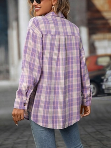 Detail view of the back pleat and purple plaid pattern on a casual flannel shirt