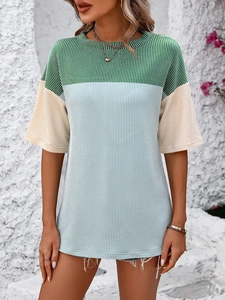 Detailed view of color block knit top with ribbed texture and crew neck design