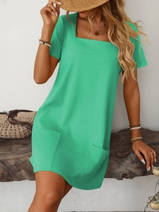 Detail of mint green square neck dress with short sleeves and functional front pockets