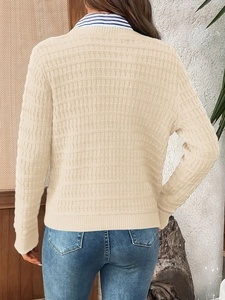 Detail of cream knit cardigan with textured relief pattern shown from a back view perspective