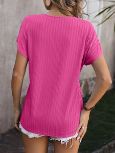 Close-up of magenta ribbed knit short sleeve top showing vertical texture and slim fit design