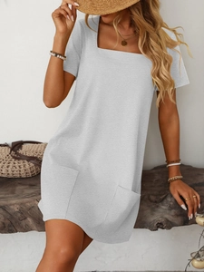 Detail view of square neck dress with short sleeves and functional front pockets