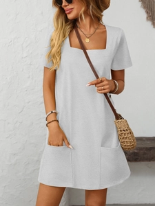 Detail shot of a light grey mini dress featuring a square neckline and front patch pockets