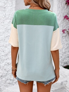 Back view of a women's color block t-shirt featuring ribbed texture in blue and green