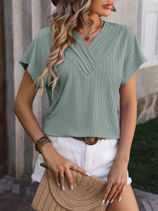 Detail of sage green knit short sleeve shirt with V-neckline and vertical stripe texture