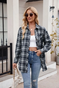 Outdoor street style view of a black and white plaid flannel shirt with a classic collar