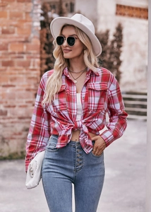 Detail view of a classic red and white plaid flannel shirt styled with a knotted hemline