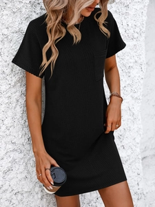 Detail of black ribbed knit short sleeve dress featuring a round neck and front chest pocket