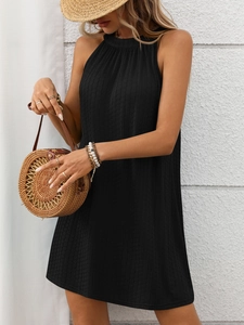 Close-up of black halter sleeveless mini dress featuring elegant vertical pleated texture