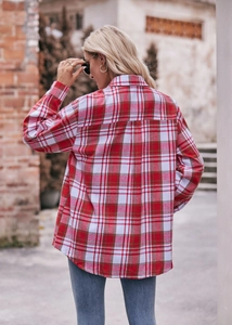 Macro shot of red plaid flannel shirt featuring a curved hem and soft brushed texture