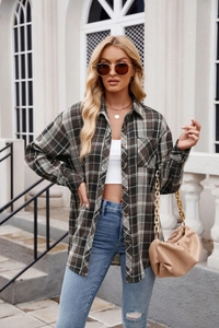 Close-up of a brown plaid shirt jacket with drop shoulders and button-up front detail