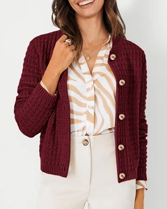 Detail view of burgundy waffle knit cardigan showing textured fabric and metallic buttons