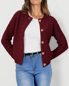 Detail of burgundy waffle knit texture and wooden buttons on a crewneck cardigan