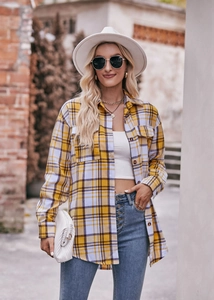 Detail of yellow and white plaid oversize flannel shirt with chest pockets and buttons