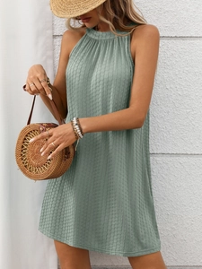 Detailed view of the vertical ribbed texture on a green halter sleeveless dress fabric