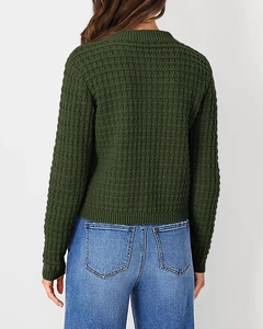 Macro view of dark green waffle knit texture and stitching on long sleeve cardigan