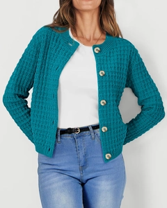 Close-up of teal waffle knit cardigan featuring textured fabric and wooden buttons