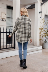 Detail of plaid long sleeve shirt showing classic beige and olive green checkered pattern