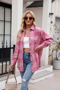 Detail of pink plaid oversized button-down shirt with chest pocket and long sleeves