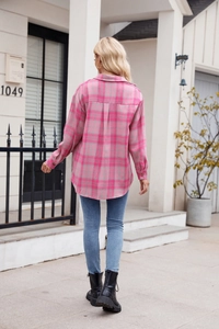 Back view of women's loose pink plaid flannel shirt with a curved hem and back pleat detail