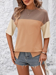 Detail of color-block knit T-shirt featuring vertical ribbed texture and side slit hem