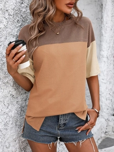 Detail of color-block waffle knit T-shirt showing round neck and textured fabric weave