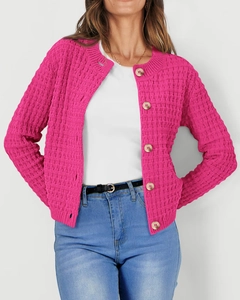 Detail of rose red knit cardigan featuring gold buttons and textured grid pattern
