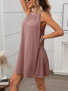 Close-up detail of pleated texture on a sleeveless halter neck dusty rose dress