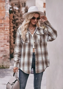 Outdoor shot of an oversize brown plaid flannel shirt with two chest pockets