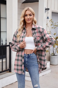 Close-up of pink and grey oversized plaid shirt with chest pocket and wood buttons
