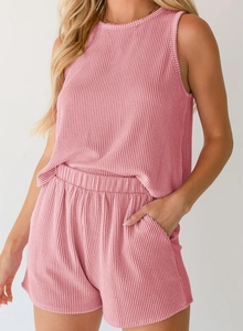 Detailed macro view of pink ribbed fabric texture on casual summer sleeveless two-piece set