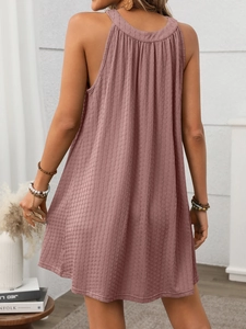 Detail view of the pleated fabric texture and back cut of the loose pink sleeveless dress