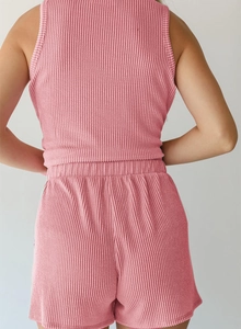 Rear view of pink ribbed knit set featuring racerback tank top and elastic waist shorts