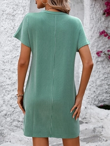 Back view of a green and white striped short sleeve dress with textured fabric detail