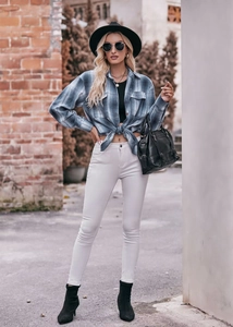 Detail of blue plaid oversize shirt with stylish front knot design and casual street style
