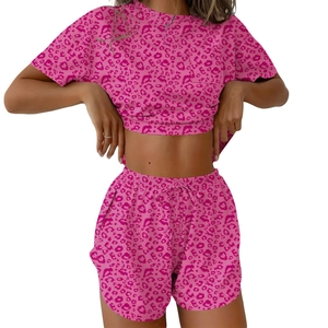 Women's two-piece pink leopard print loungewear set with crop top and drawstring shorts