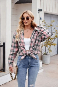 Detail of pink plaid flannel shirt for women styled with a knot and chain bag