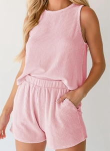 Close-up of pink ribbed fabric texture on sleeveless top and elastic waist shorts