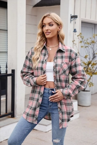 Close-up of pink and grey plaid flannel shirt with front pocket and button detail